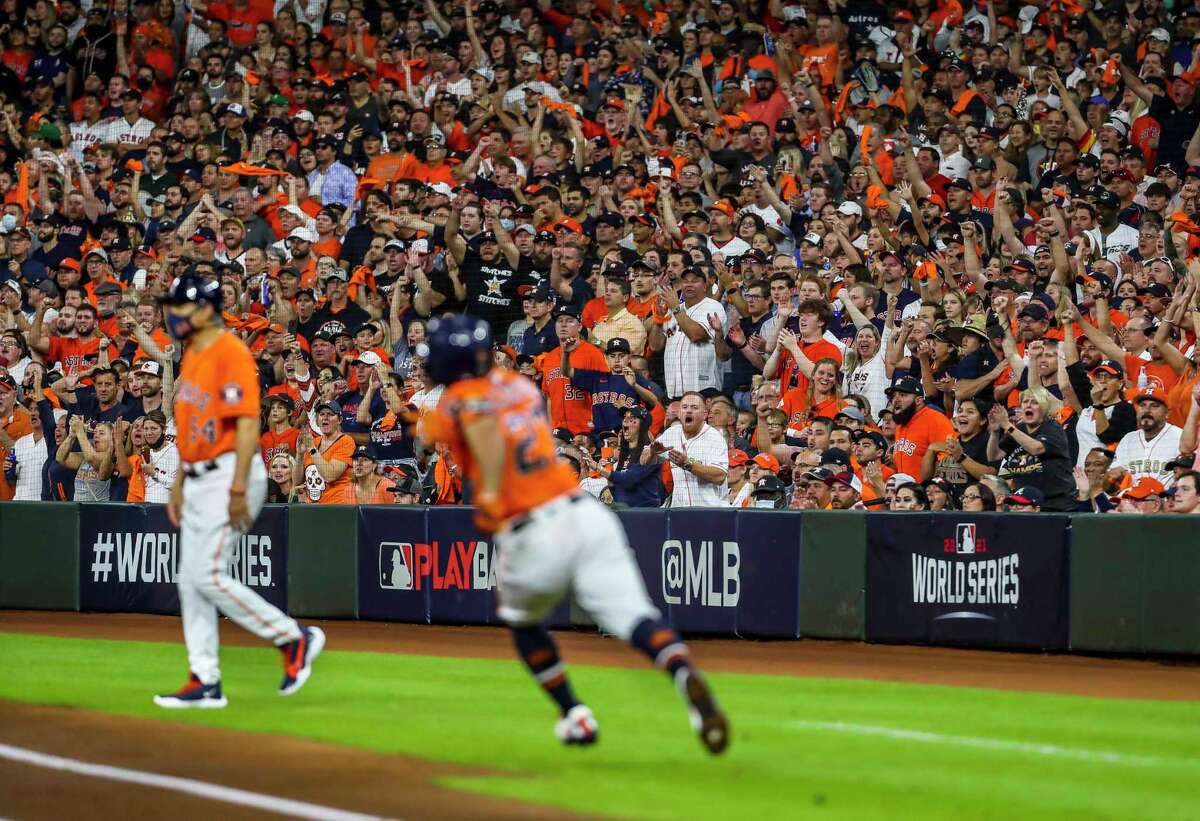 Astros fans cheer as Houston Astros second baseman Jose Altuve (27) runs up the first base line after hitting a double to left to lead off the first inning in Game 2 of the World Series on Wednesday, Oct. 27, 2021 at Minute Maid Park in Houston.