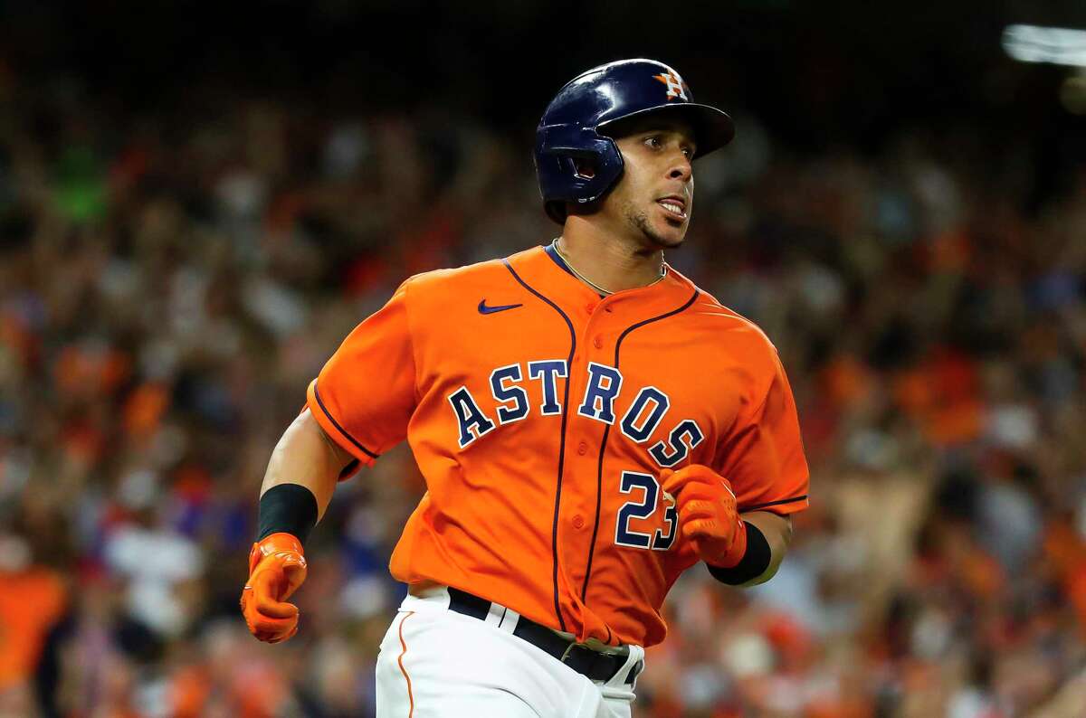 Houston Astros left fielder Michael Brantley (23) runs to first as he hits an RBI single that scores Houston Astros first baseman Yuli Gurriel (10) giving the Astros a 5-1 lead during the second inning in Game 2 of the World Series on Wednesday, Oct. 27, 2021 at Minute Maid Park in Houston.