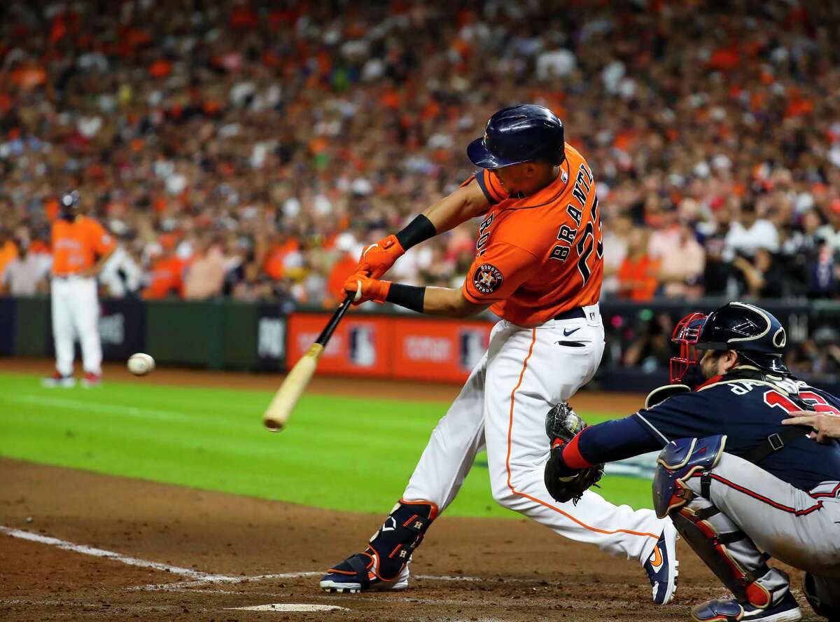 Houston Astros left fielder Michael Brantley (23) hits an RBI single that scores Houston Astros first baseman Yuli Gurriel (10) giving the Astros a 5-1 lead during the second inning in Game 2 of the World Series on Wednesday, Oct. 27, 2021 at Minute Maid Park in Houston.