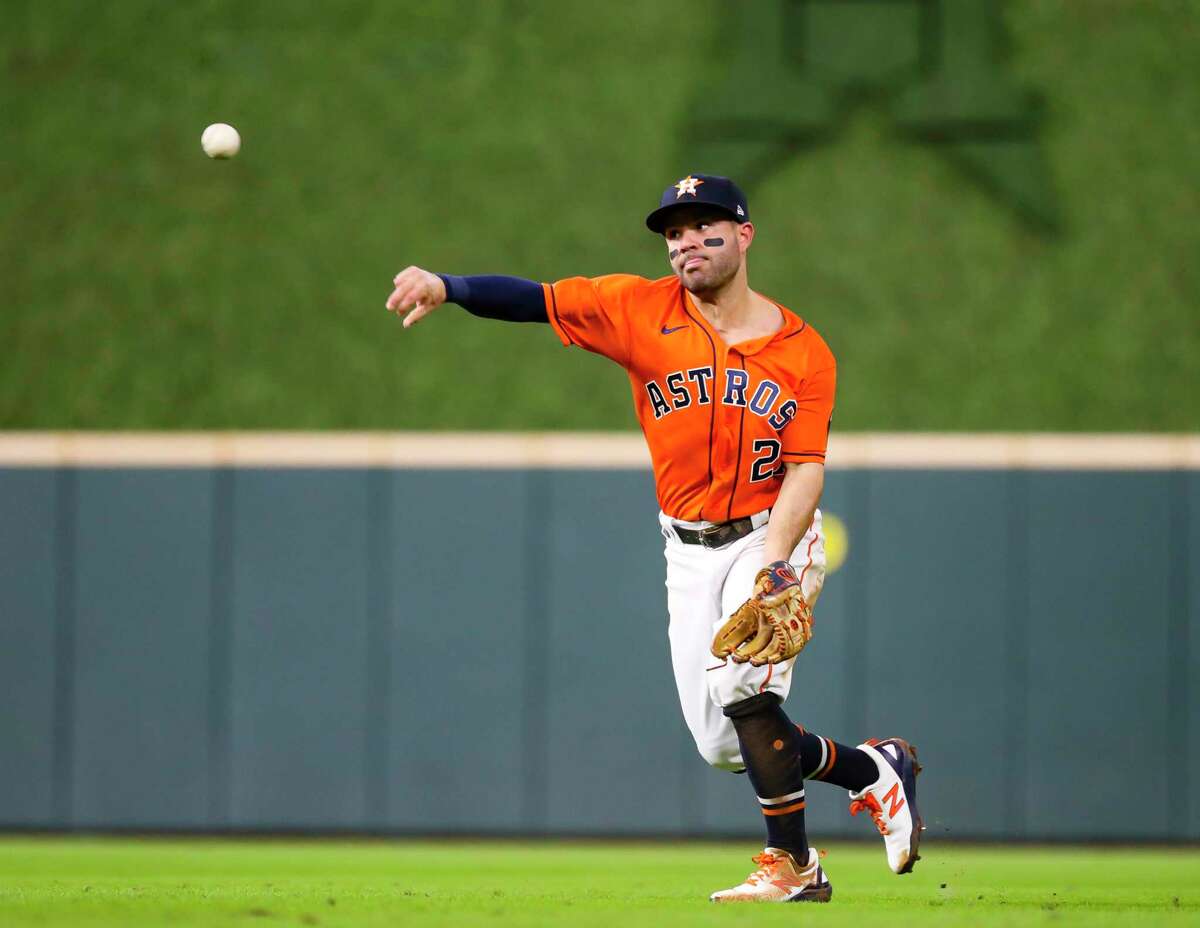 Houston Astros second baseman Jose Altuve (27) throws out Atlanta Braves first baseman Freddie Freeman (5) during the third inning in Game 2 of the World Series on Wednesday, Oct. 27, 2021 at Minute Maid Park in Houston.