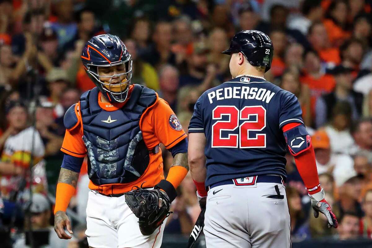 Atlanta Braves right fielder Joc Pederson (22) looks at Houston Astros catcher Martin Maldonado (15) after Pederson struck out swinging during the fourth inning in Game 2 of the World Series on Wednesday, Oct. 27, 2021 at Minute Maid Park in Houston.