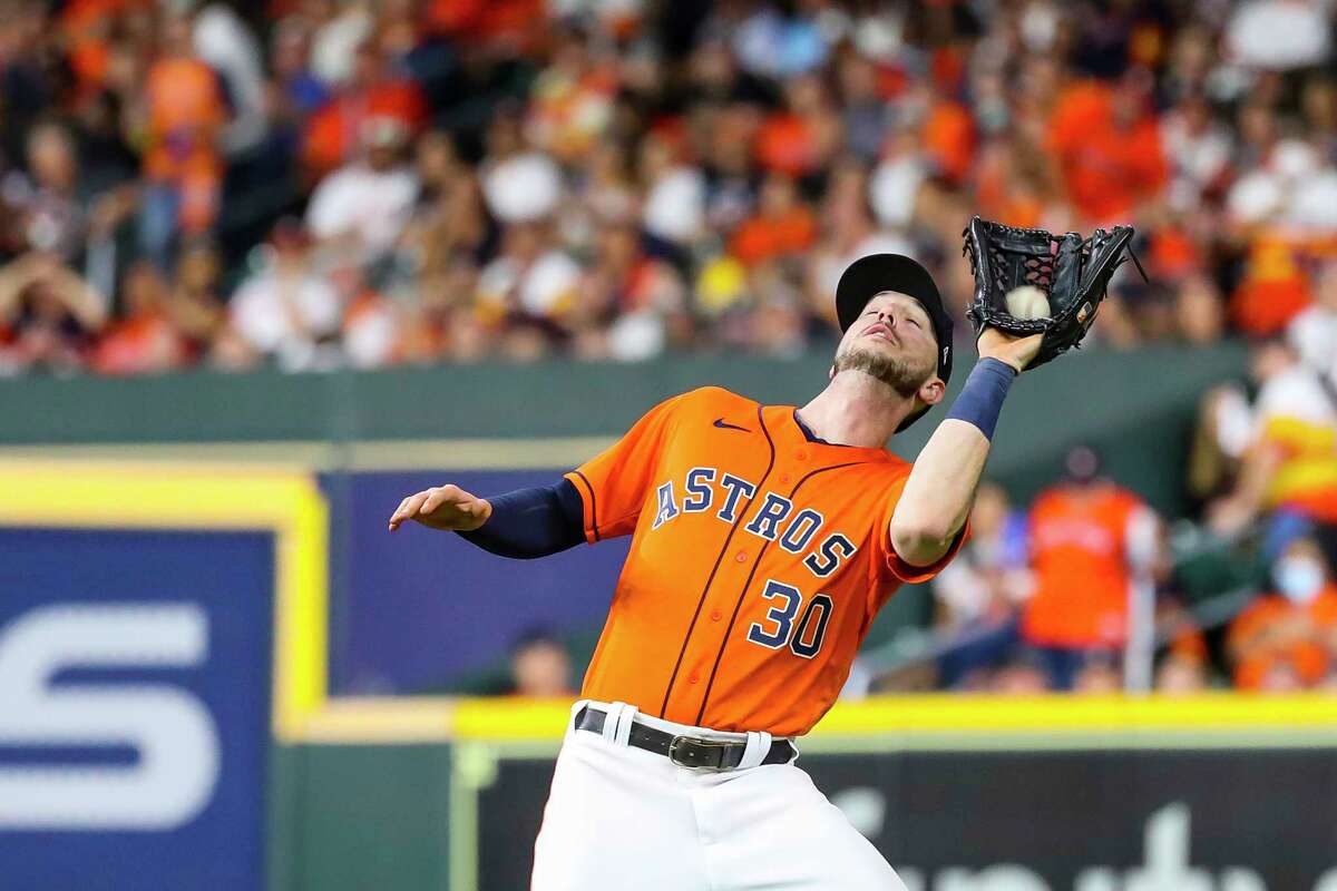Houston Astros right fielder Kyle Tucker (30) catches a fly out from Atlanta Braves center fielder Adam Duvall (14) to end the top of the fourth inning in Game 2 of the World Series on Wednesday, Oct. 27, 2021 at Minute Maid Park in Houston.