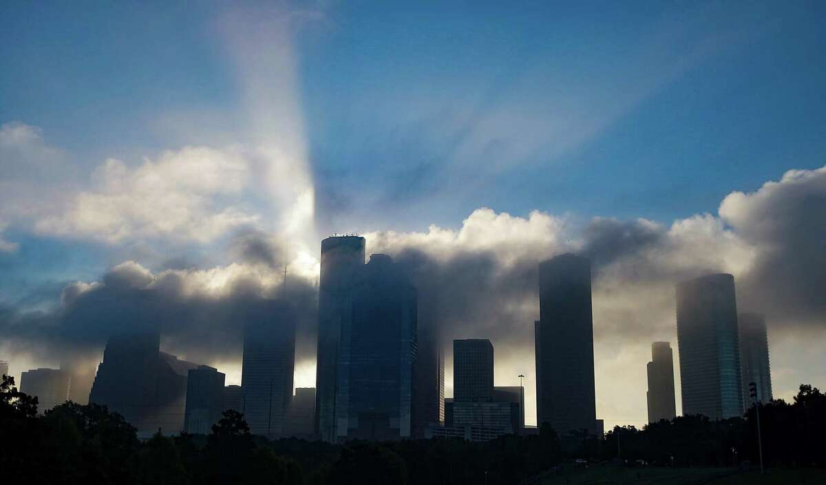 An early morning fog rolls out of downtown Houston on Thursday, Oct. 21, 2021.