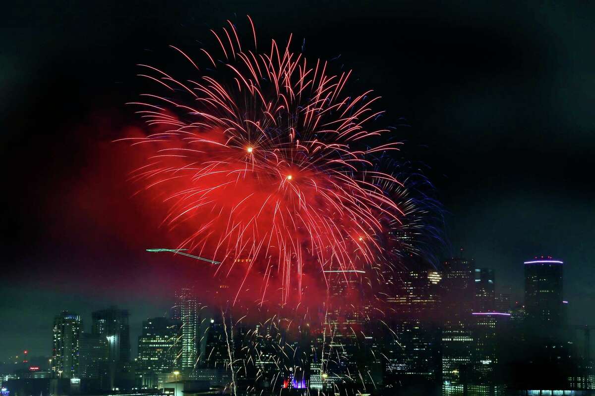 Fireworks fly over the skyline as seen from the 25th floor penthouse of the Windsor Memorial during the annual fireworks display Sunday, July 4, 2021 in Houston, TX.