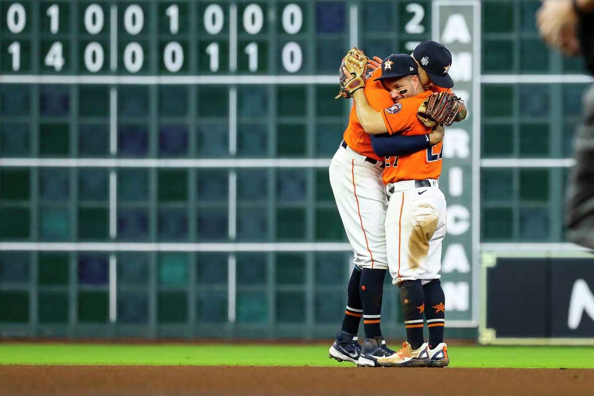 Houston Astros shortstop Carlos Correa (1) and Houston Astros second baseman Jose Altuve (27) hug at the end of the Astros 7-2 win of Game 2 of the World Series on Wednesday, Oct. 27, 2021 at Minute Maid Park in Houston.
