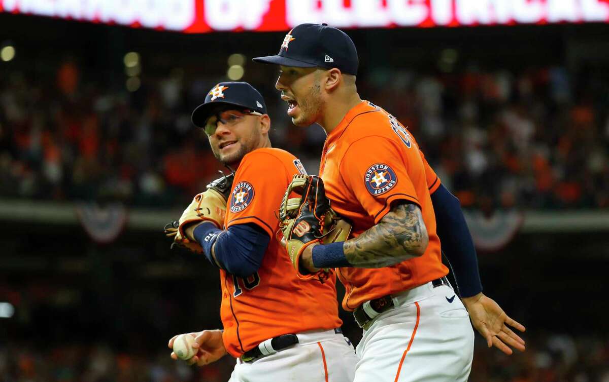 Houston Astros first baseman Yuli Gurriel (10) and Houston Astros shortstop Carlos Correa (1) run back to the dugout at the end of the top of the seventh inning in Game 2 of the World Series on Wednesday, Oct. 27, 2021 at Minute Maid Park in Houston.
