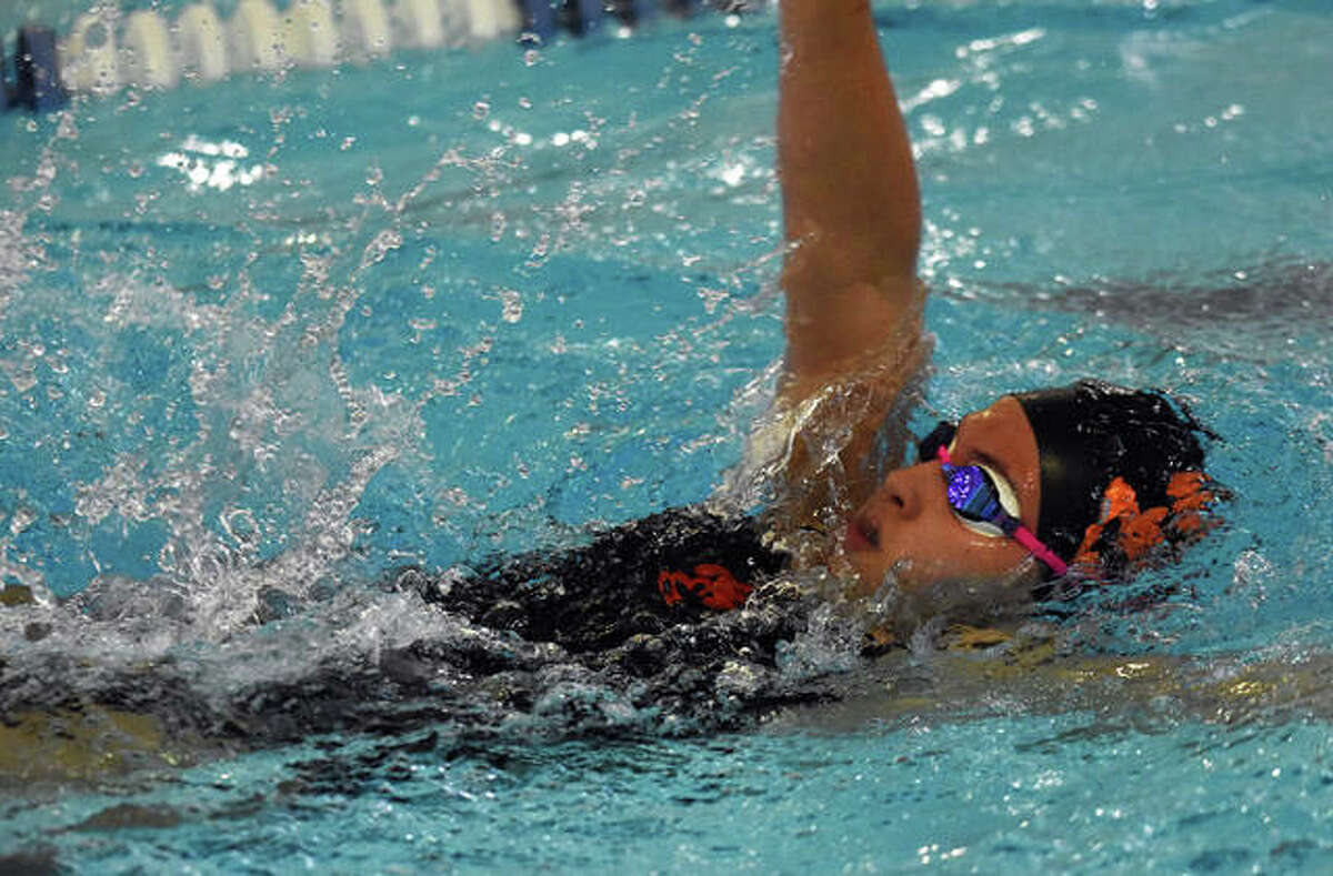 Edwardsville’s Emily Moody competes in the backstroke portion of the individual medley race on Wednesday inside Chuck Fruit Aquatic Center.