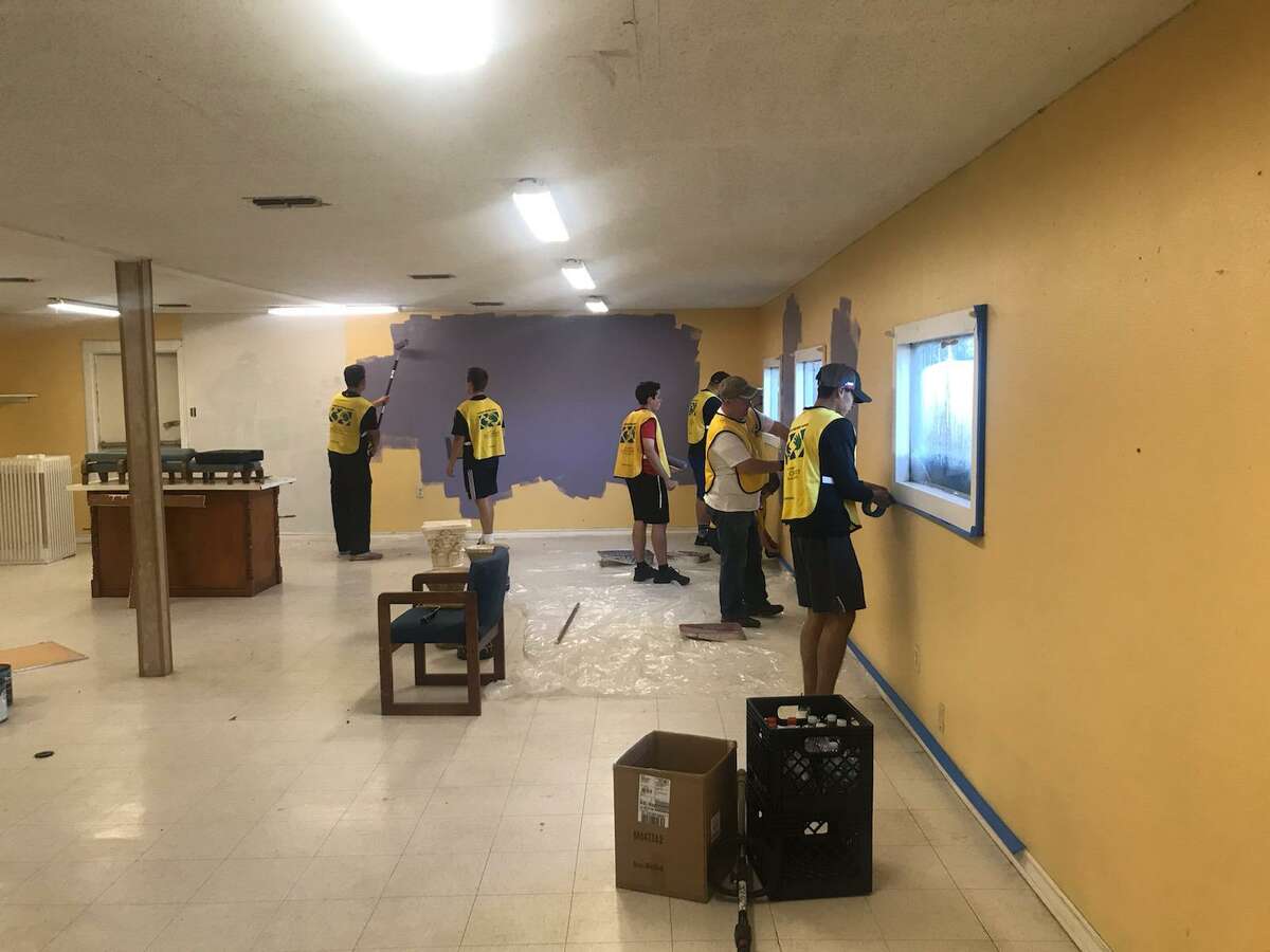 Volunteers painting kitchen dining area.