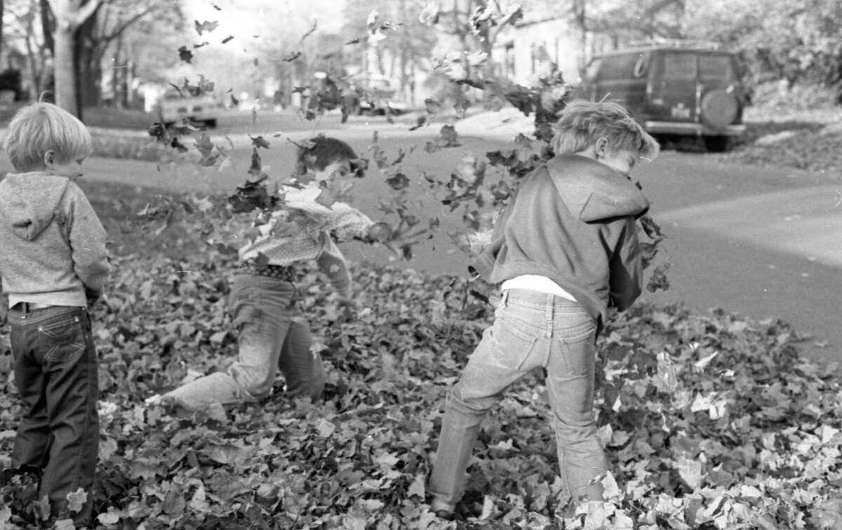 The leaves were flying as kingdoms rose and fell on a warm October afternoon of play on Walnut Street. Shown here flinging leaves are (from left) Jason Carl, Doug Keller and Eddie Verrett. The photo was published in the News Advocate on Oct. 31, 1981. (Manistee County Historical Museum photo)