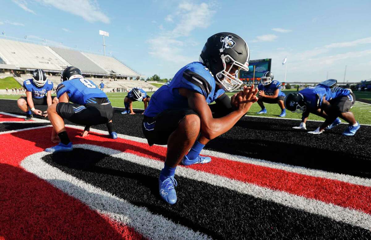 New Caney quarterback Cornelius Banks (10) stretches before a non-district high school football game at Randall Reed Stadium, Friday, Sept. 3, 2021, in New Caney.