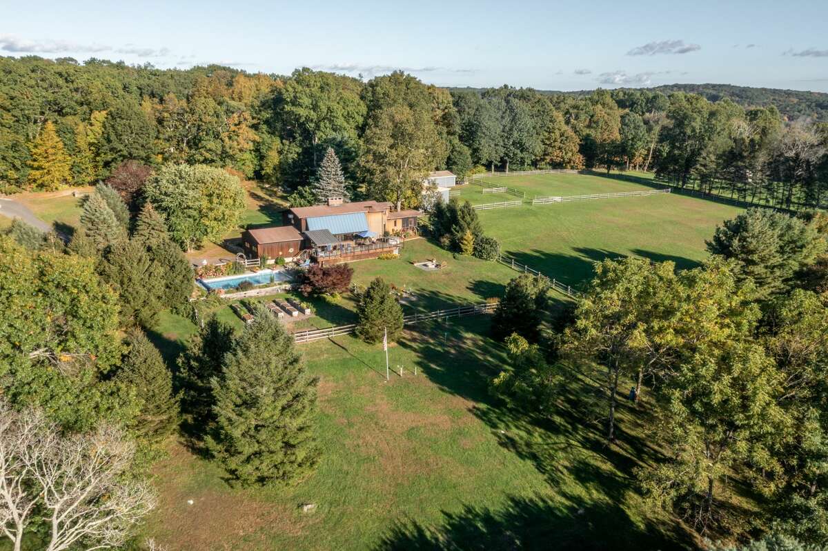 The home on 14 Old Boston Post Drive in Roxbury, Conn. has 7 acres of land that includes horse paddocks and a barn. 