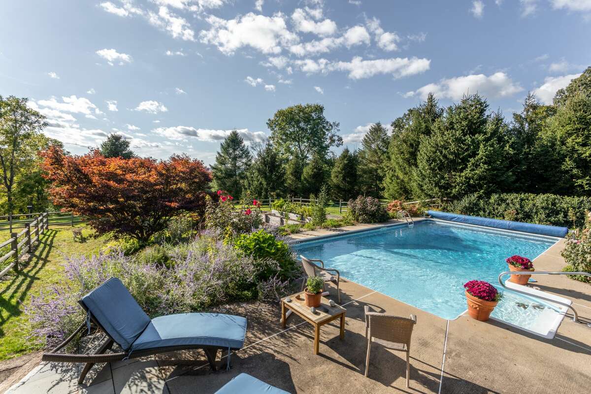 The home on 14 Old Boston Post Drive in Roxbury, Conn. has a heated pool and patio space. 