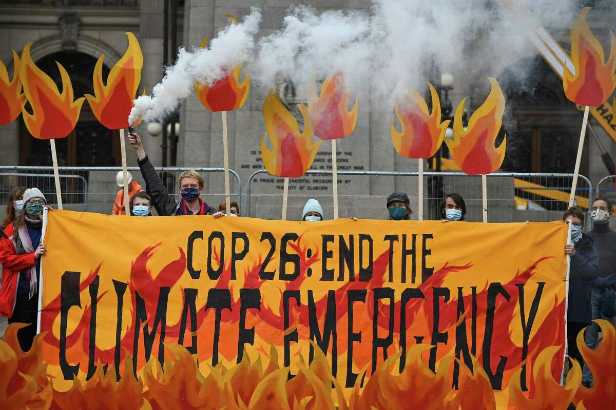 Activists will welcome world leaders to COP26 with a field of climate fire in George Square on October 28, 2021 in Glasgow, Scotland. The group symbolically set George Square “on fire” with an art installation of faux flames, smoke, and banners, showcasing the climate emergency, and massive fire extinguishers highlighting actions world leaders should take at the upcoming COP26 climate negotiations.