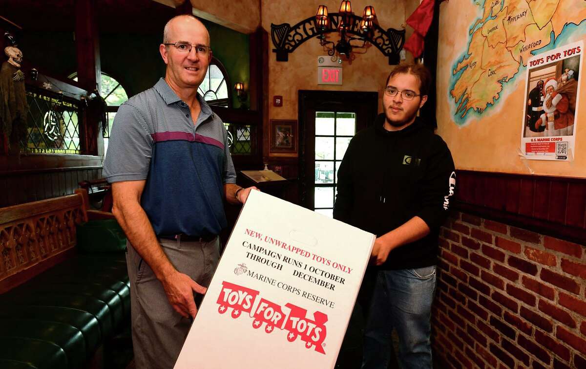 Next Steps students including Justin Smith, 18, asks businesses in SONO like O'Neill's Pub owner Ollie O"Neill to set up Toys for Tots dropbox Thursday, October 28, 2021, in Norwalk, Conn.