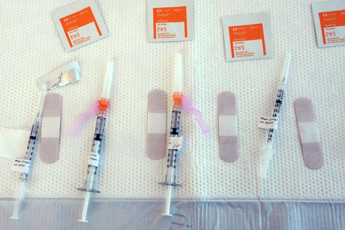 Syringes filled with COVID-19 vaccine wait on a table at Hartford HealthCare’s new mass vaccination clinic on the west campus of Sacred Heart University, in Fairfield, Conn. March 10, 2021.
