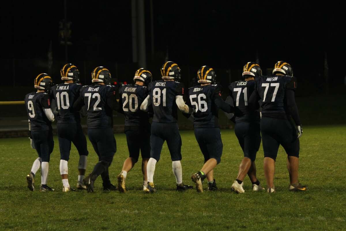 The Manistee seniors walk the length of their home field one last time following a loss to Tri-County. 