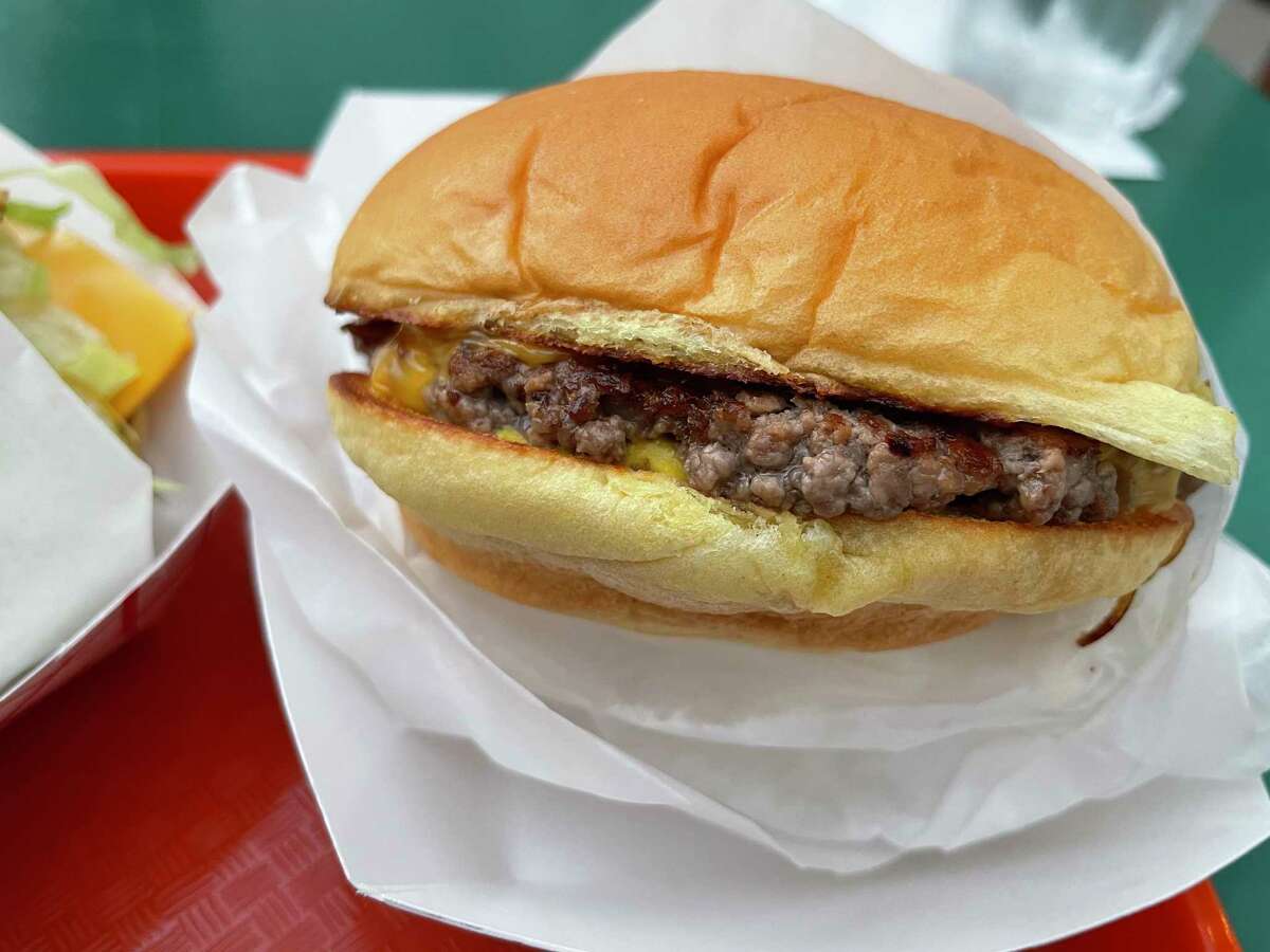 The Original Fried Onion burger from Lovely's features American cheese, pan-fried onions and pickles.
