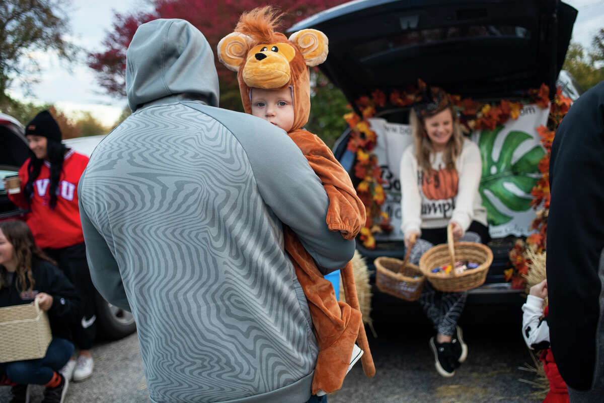 Children collect candy during a trunk-or-treat event Thursday, Oct. 28, 2021 at Grove Park in Midland. (Katy Kildee/kkildee@mdn.net)