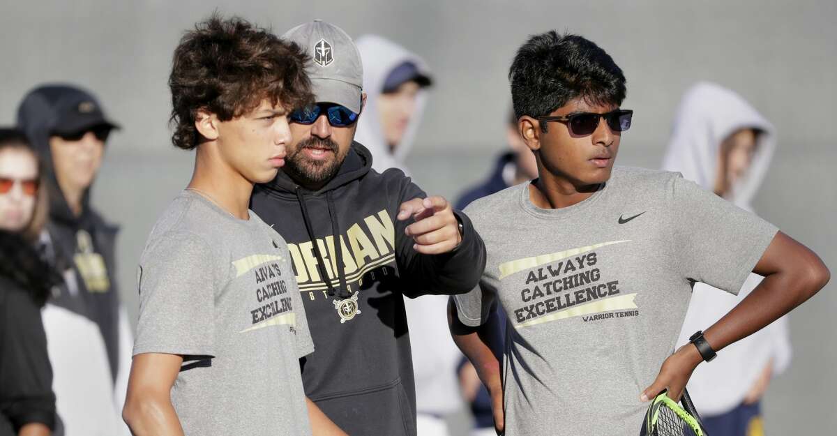 Jordan Katy's Vincent Rivas, left, and Aneesh Melachuri, right, talk with coach Tyler Esterline, center during their UIL State Team Tennis Class 5A Semifinals doubles match against Highland Park, held at Texas A&M Thursday, Oct. 28, 2021 in College Station, TX.