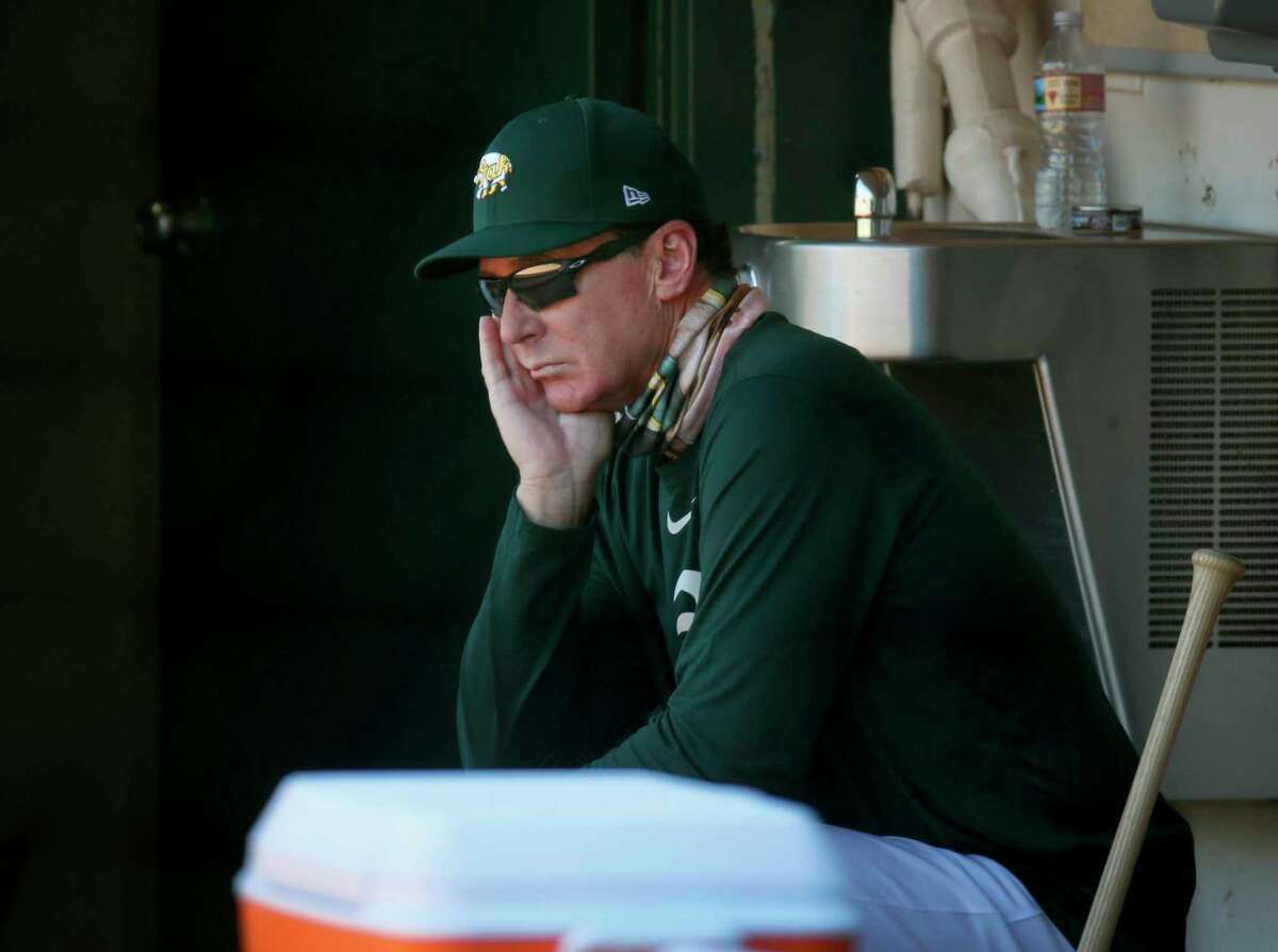 Manager Bob Melvin watches the Oakland A's summer training camp from the dugout at the Coliseum in Oakland, Calif. on Saturday, July 11, 2020.