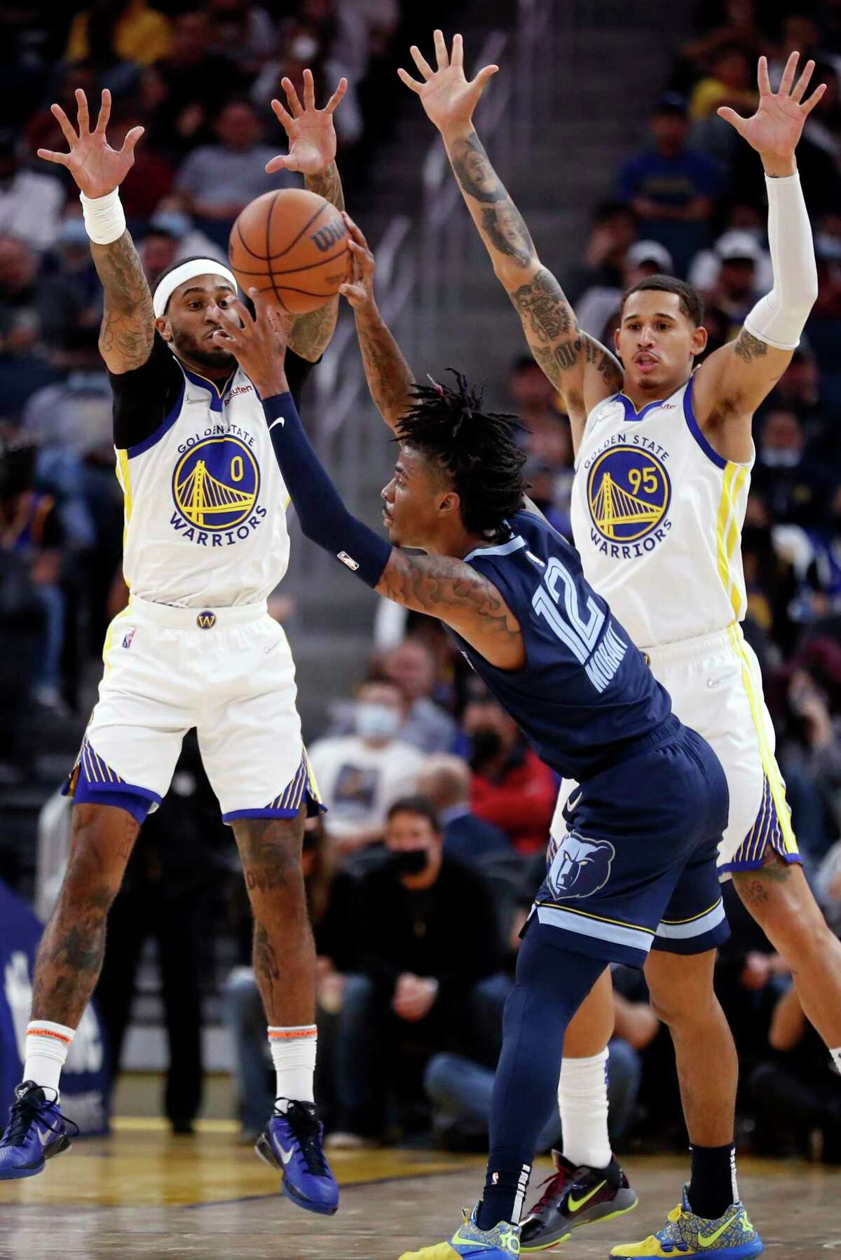Golden State Warriors' Gary Payton II and Juan Toscano-Anderson double team Memphis Grizzlies' Ja Morant in 3rd quarter during NBA game at Chase Center in San Francisco, Calif., on Thursday, October 28, 2021.
