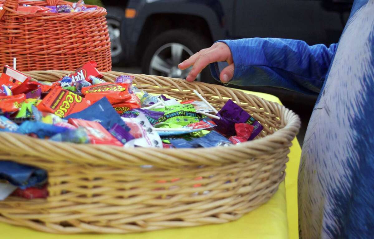 Children grab Halloween candy on Oct. 31, 2020.