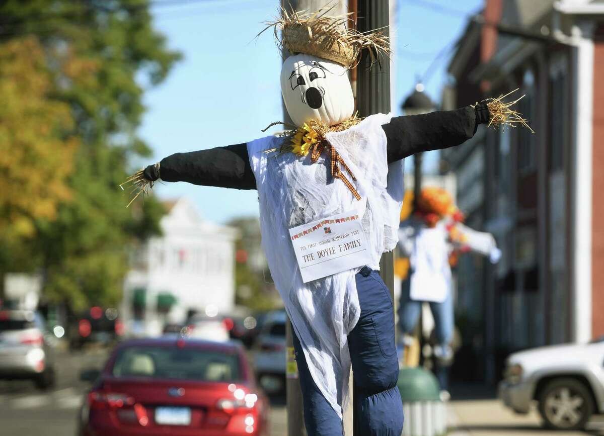 Scarecrows decorate every lightpole for the Downtown Milford Association's first annual scarecrow fest on Broad Street in Milford on Tuesday.