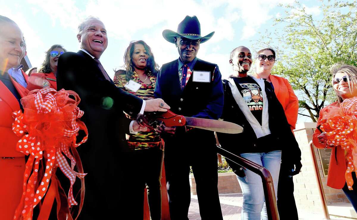 Lamar State College Orange President Tom Johnson gathers with Clarence "Gatemouth" Brown's niece Brenda Johnson and brother Bobby Brown for a ribbon cutting during the opening celebration for the campus' new Gatemouth Plaza Thursday. Photo made Thursday, October 28, 2021 Kim Brent/The Enterprise