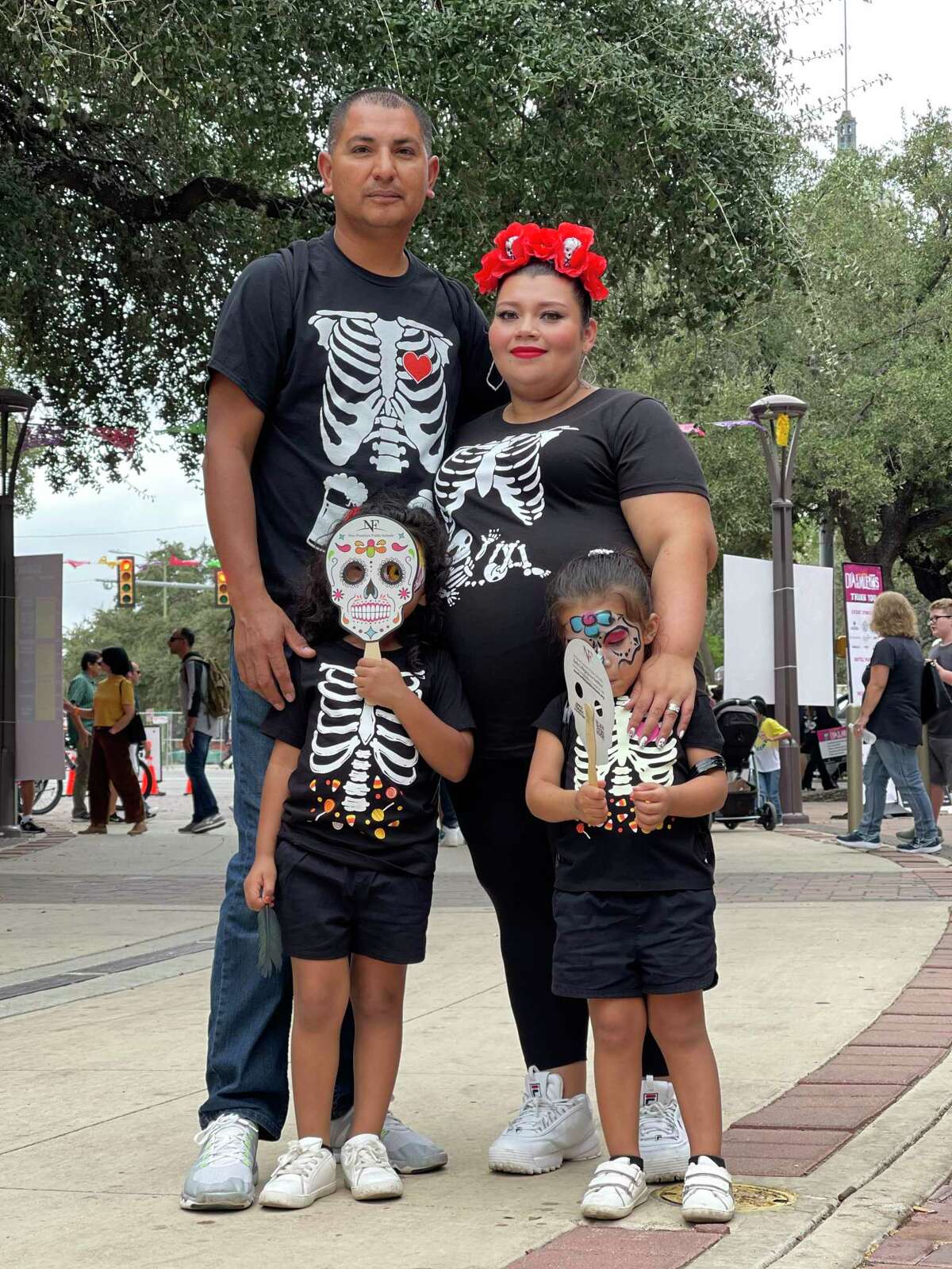 Melissa Cardona, from Honduras, and Carlos Aguilar, from Mexico, and their two daughters. The family drove from Houston for Muertos Fest because their young daughters, Belen and Fernanda, are “obsessed” with “Coco,” the Disney Pixar animation about the tradition.