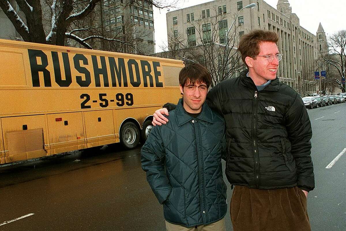 Actor Jason Schwartzman and director Wes Anderson stand in front of their promotional bus for the film "Rushmore". (Photo by George Rizer / The Boston Globe via Getty Images)