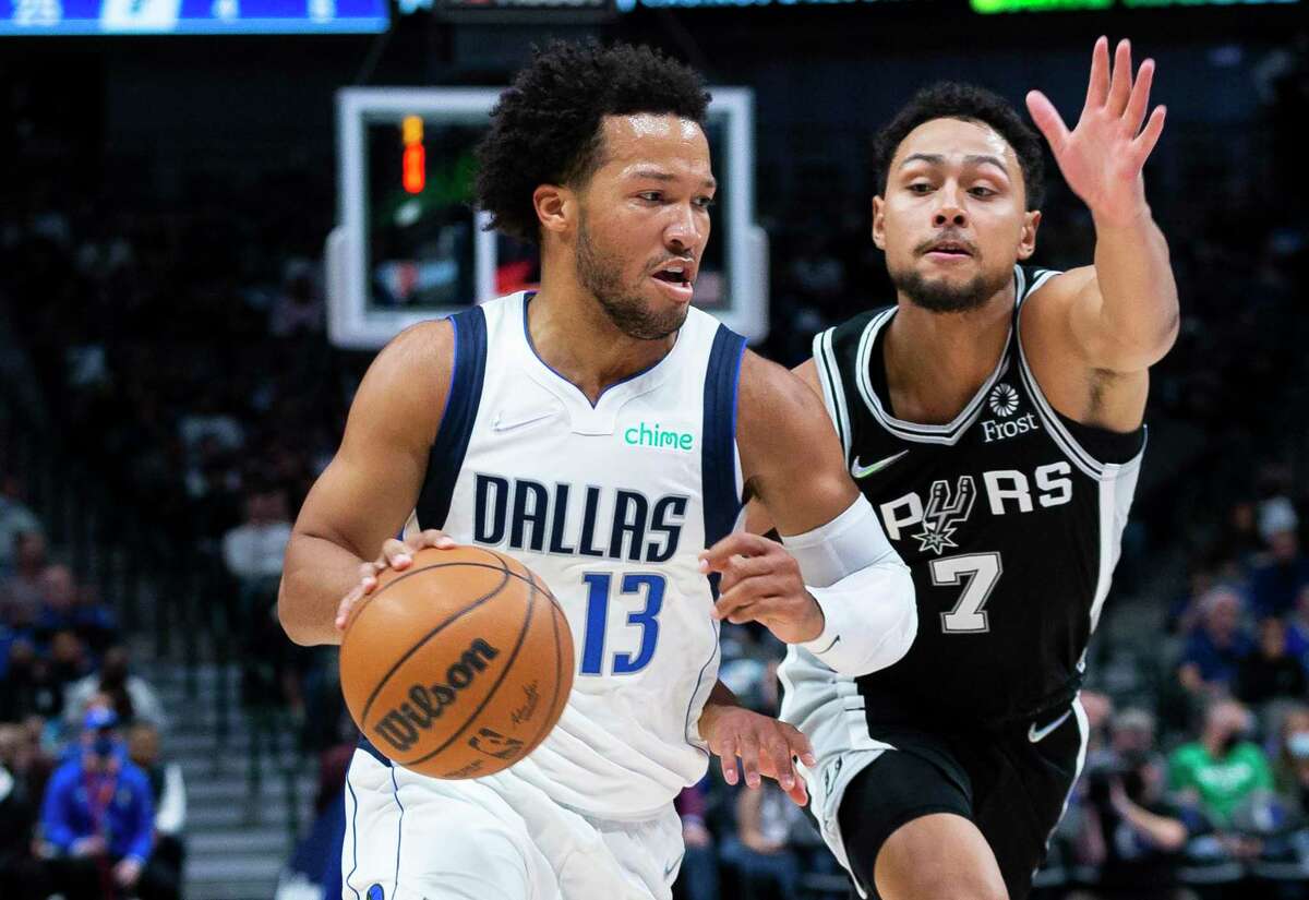 Dallas Mavericks guard Jalen Brunson (13) controls the ball as San Antonio Spurs guard Bryn Forbes (7) defends during the first half of an NBA basketball game Thursday, Oct. 28, 2021, in Dallas.