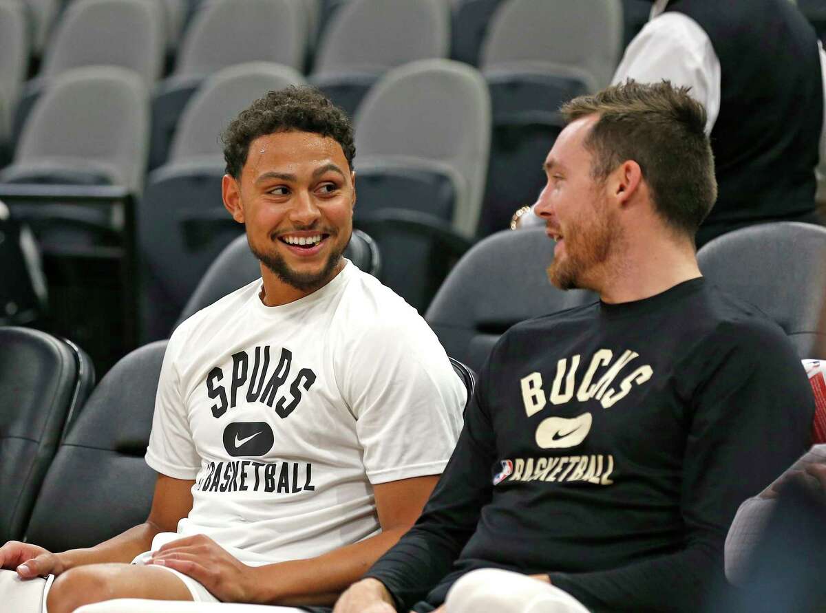 Bryn Forbes #7 of the San Antonio Spurs talks with former teammate Pat Connaughton #24 of the Milwaukee Bucks before the start of their game at AT&T Center on October 23, 2021 in San Antonio, Texas.