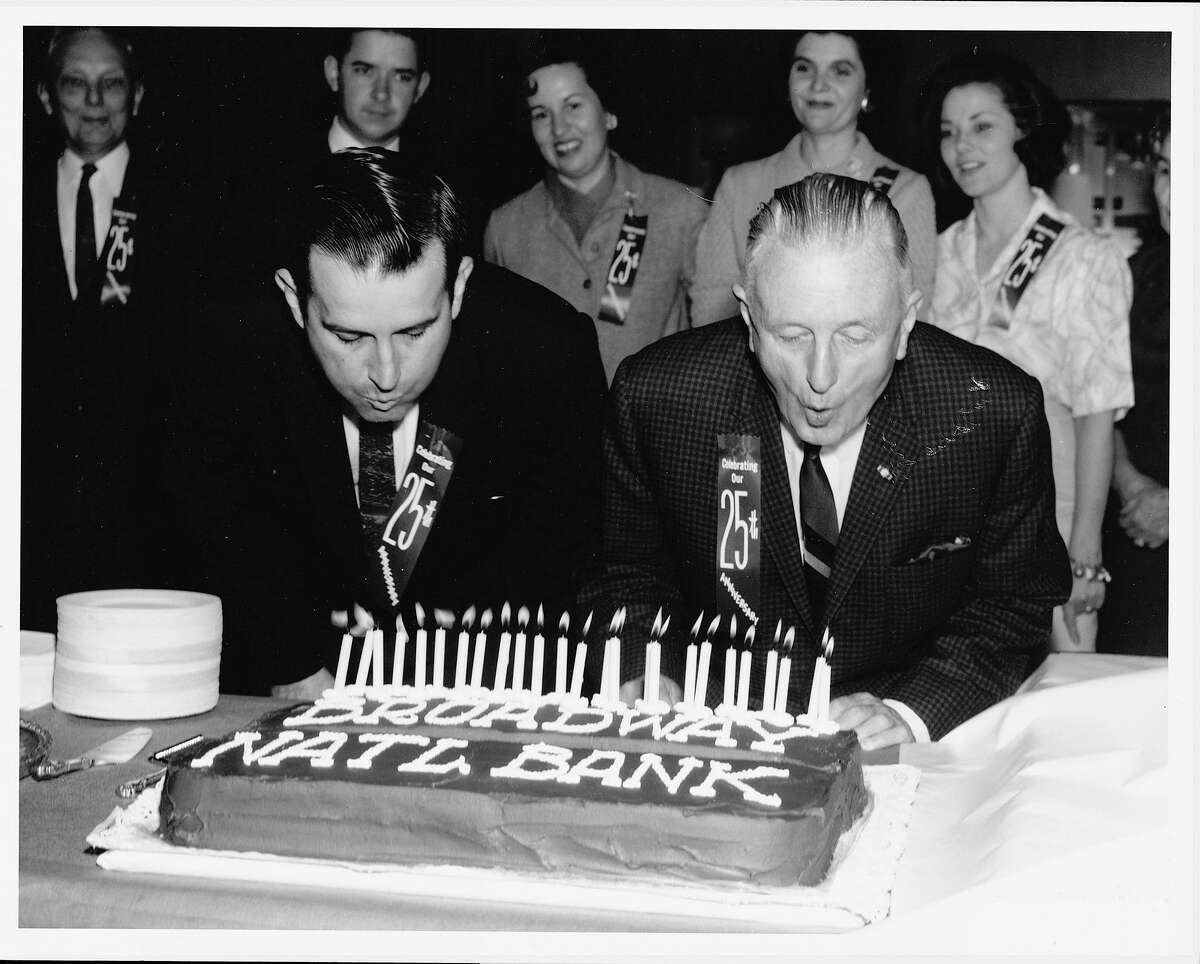Charlie Cheever Jr., left, and Charlie Cheever Sr. blow out the candles on a 25th anniversary cake at Broadway Bank in February 1966. The bank is been operating for 80 years.