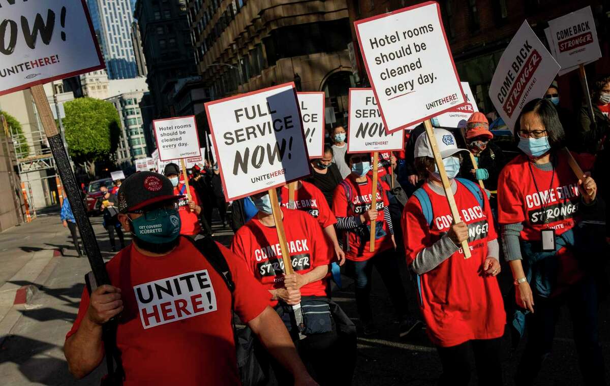 Worker march through downtown San Francisco on Thursday as hospitality employees, union organizers and supportive demonstrators descended on the Westin St. Francis hotel to demand better jobs.