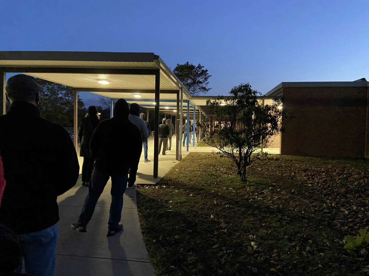 Voters line up outside Madison Middle School before the polls open at 6 a.m. on Election Day, 2020.