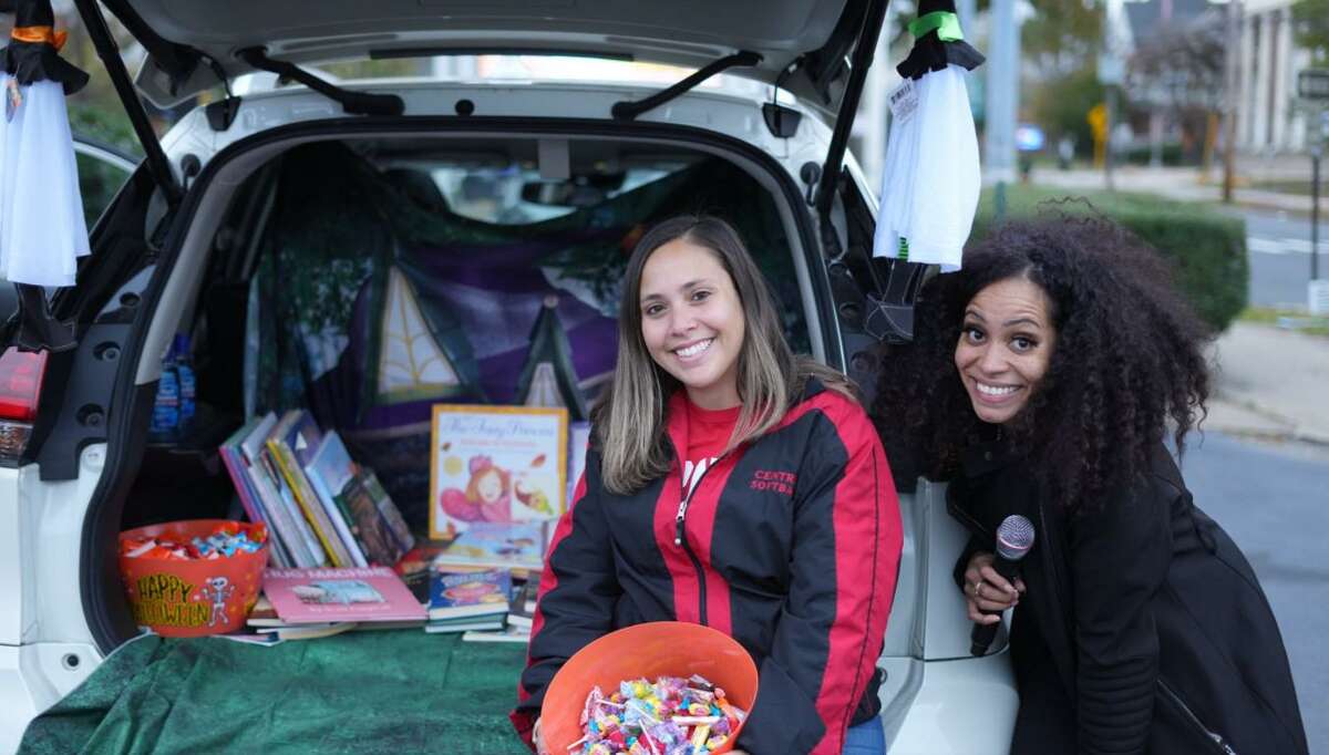 Erika Castillo and Christine Baptiste-Perez distributed books and candy at Democratic school board candidates' Trunk-or-Treat Book Giveaway event.