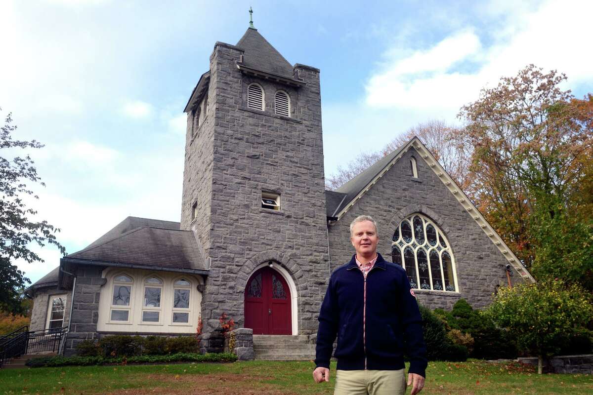 Rev. Timothy Hare poses in front of Trumbull Congregational Church, in Trumbull, Conn. Oct. 28, 2021.
