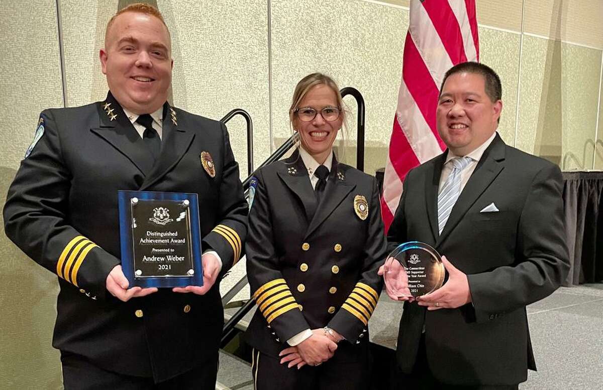 Trumbull Emergency Medical Services has honored paramedic supervisor Andrew Weber (left) with its Distinguished Achievement Award, and William Chin, the town of Trumbull’s director of information technology (far right), was recognized as the EMS Supporter of the Year. In between them is Leigh Goodman, Trumbull Director of Emergency Medical Services.