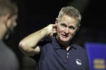 Warriors head coach Steve Kerr talks with reporters after having his portrait made as the Golden State Warriors held their media day for the 2021-22 season at Chase Center in San Francisco, Calif., on Monday, September 27, 2021.