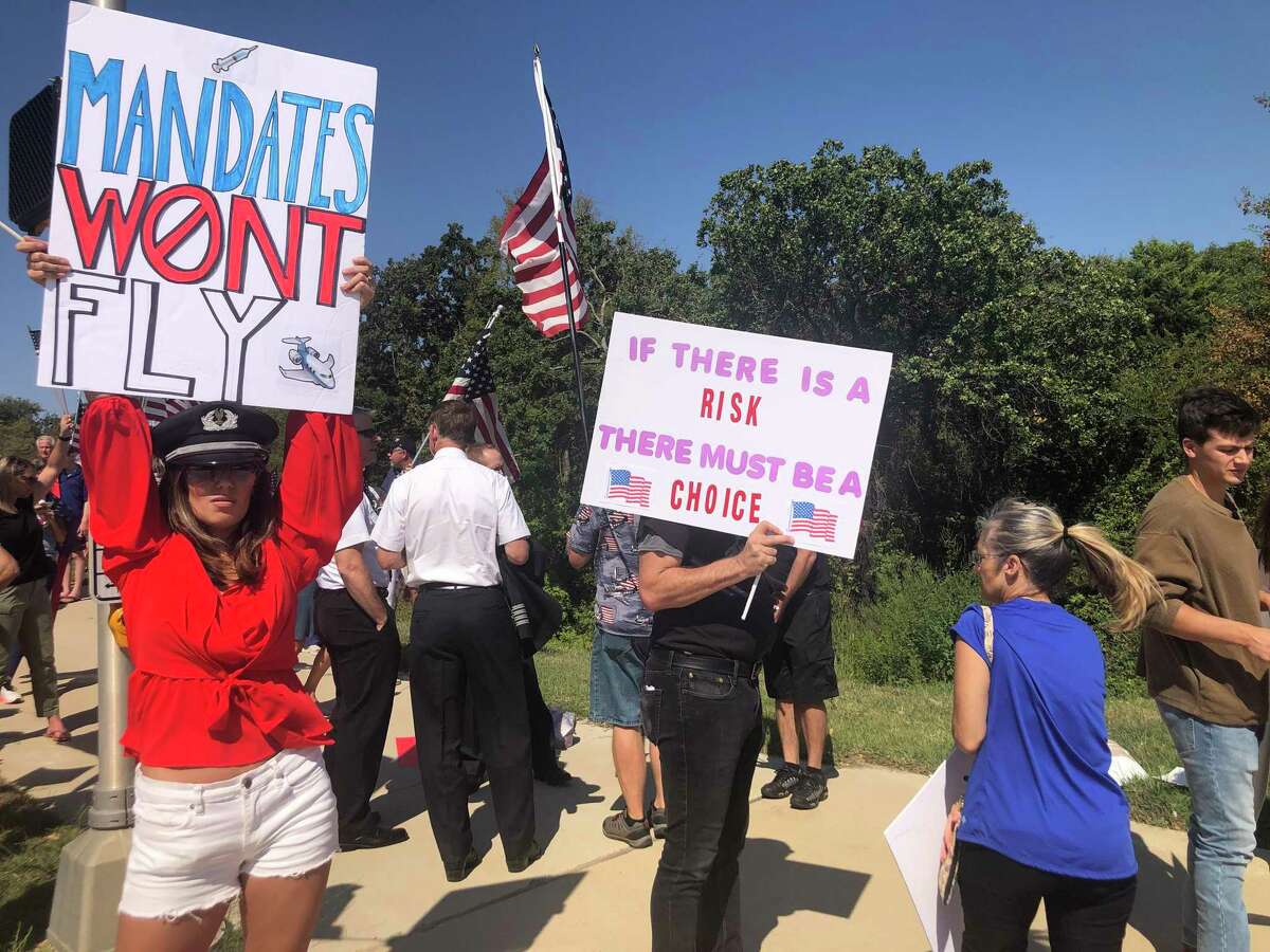 A group of about 250 American Airlines employees and supporters rally outside American Airlines headquarters in Fort Worth, Texas, on Oct. 7, 2021. The group was protesting vaccine mandates for employees after the company said any worker that is not fully vaccinated would be fired. (Kyle Arnold/Dallas Morning News/TNS)