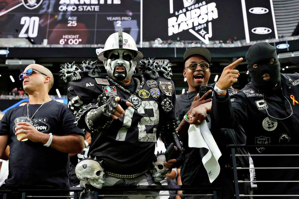 Las Vegas Raiders fans pose ahead of the game between the Baltimore Ravens and the Raiders at Allegiant Stadium on Sept. 13 in Las Vegas.