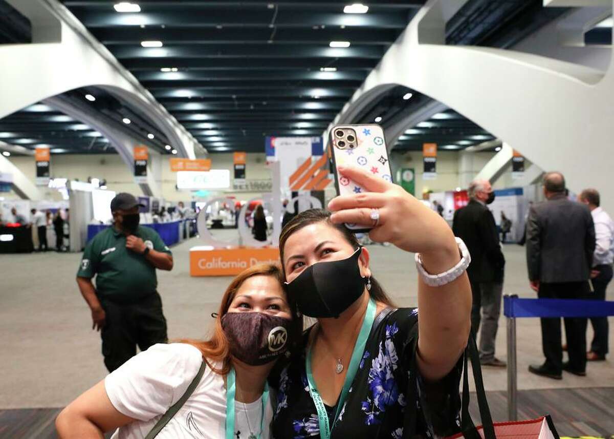 Alegria Ledda (right) takes a photo of her and Maryjane Bair (left) as they document their attendance at the California Dental Association convention at Moscone South in San Francisco this past September.