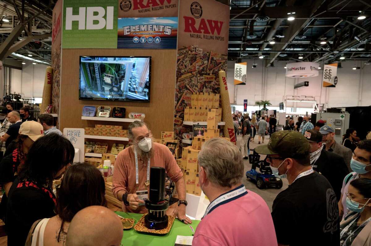 Ian Kobe, creative director and head of product development at HBI International, demonstrates ConeXpress, a machine that emulates a human packing a cone, at the HBI International booth during MJBizCon at the Las Vegas Convention Center.