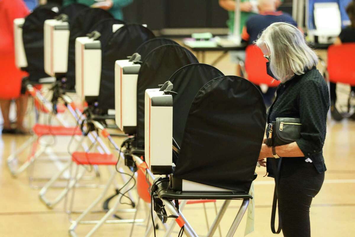 A woman votes on the last day of early-voting Friday, Oct. 29, 2021, at the West Gray Metropolitan Multi-Services Center in Houston.