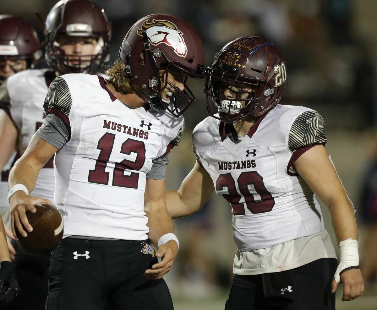 Magnolia West quarterback Brock Dalton (12) celebrates with running back Hunter Bilbo (20) after defeating New Caney 31-24 during a high school football game at Randall Reed Stadium, Friday, Oct. 29, 2021, in New Caney. Magnolia West defeated