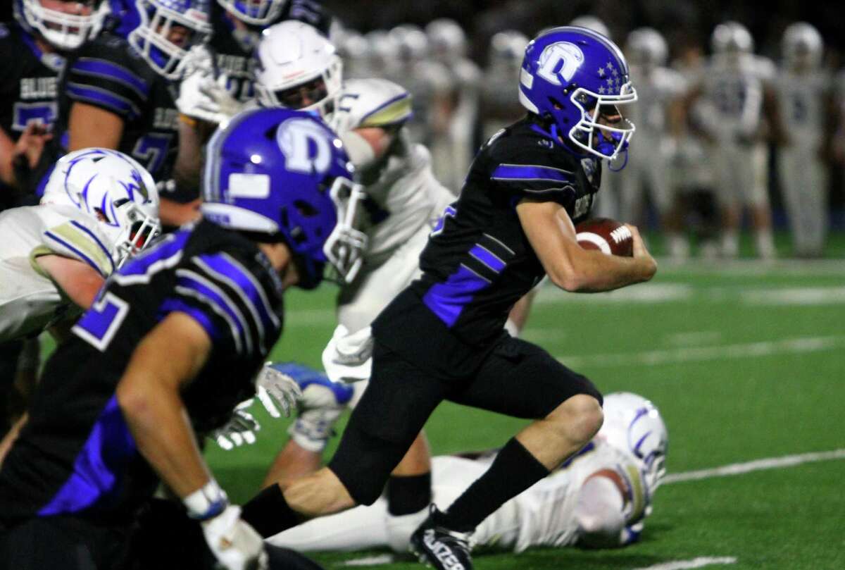 Darien's Miles Drake (3) runs up the middle on his way to score a touchdown during high school football action against Newtown, in Darien, Conn., on Friday September 18, 2021.
