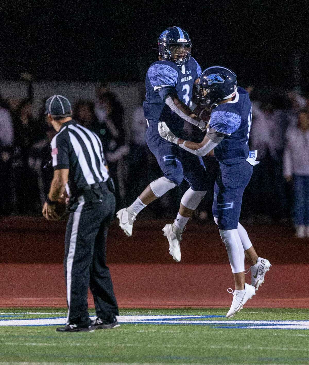 Johnson running back Ben McCreary, left, celebrates his touchdown Friday, Oct. 29, 2021 at Heroes Stadium with teammate Alejandro Tavarez during the Jaguars?• game against Reagan. The Jaguars beat the Rattlers 46-43 in overtime.