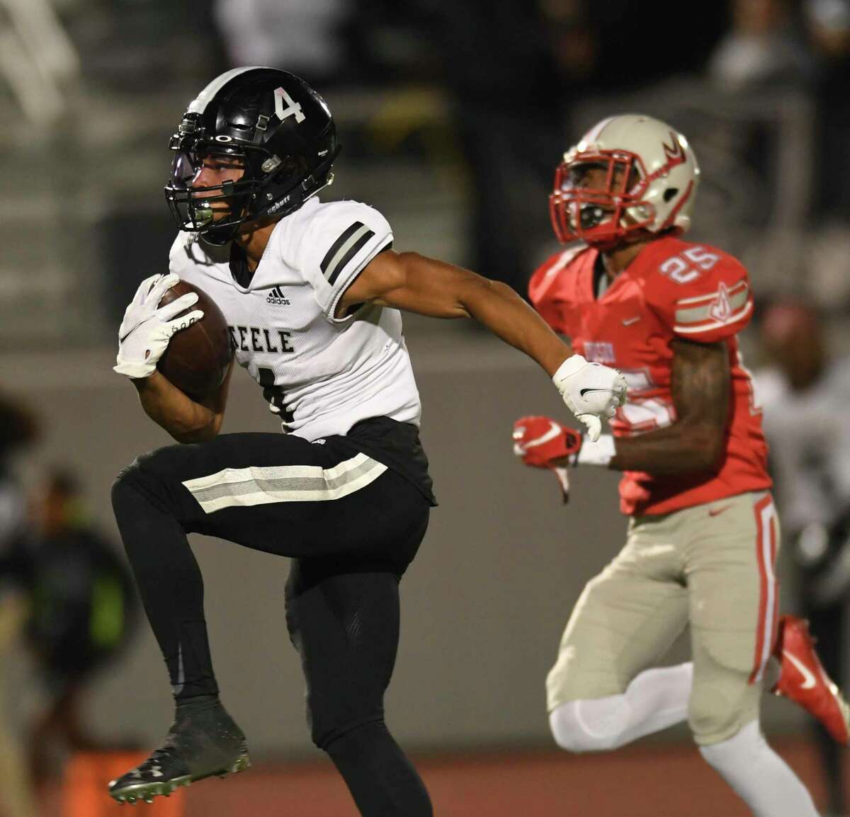 Steele's Teshaun Singleton runs for a touchdown as Dantrelle Eggleston (25) of Judson chases during high school football action in Converse on Friday, Oct. 29, 2021. Steele won, 35-30.