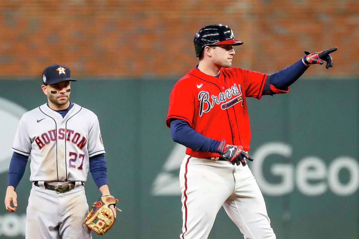 Atlanta Braves third baseman Austin Riley (27) celebrates on second next to Houston Astros second baseman Jose Altuve (27) after hitting an RBI double to score Atlanta Braves left fielder Eddie Rosario (8) and give the Braves a 1-0 lead during the third inning of Game 3 of the World Series on Friday, Oct. 29, 2021 at Truist Park in Atlanta.