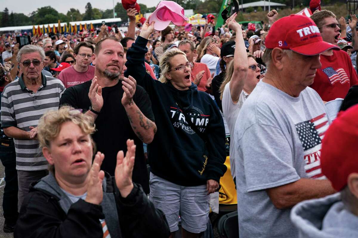 Supporters cheer after the national anthem before former president Trump arrives to speak at the Oct. 9 rally at the Iowa State Fairgrounds.